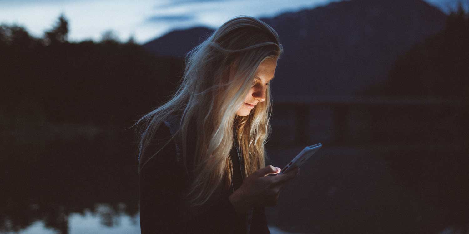 woman looking at phone outside