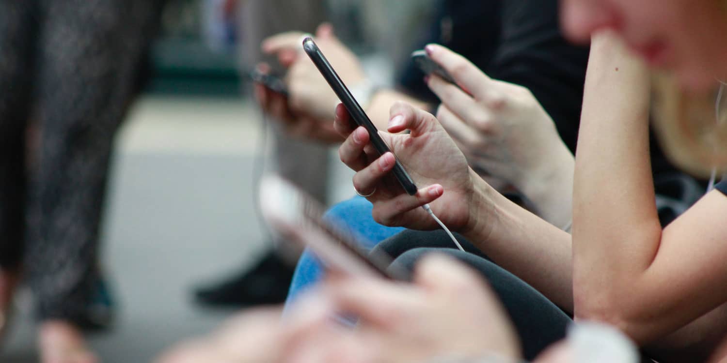 group of people using phones