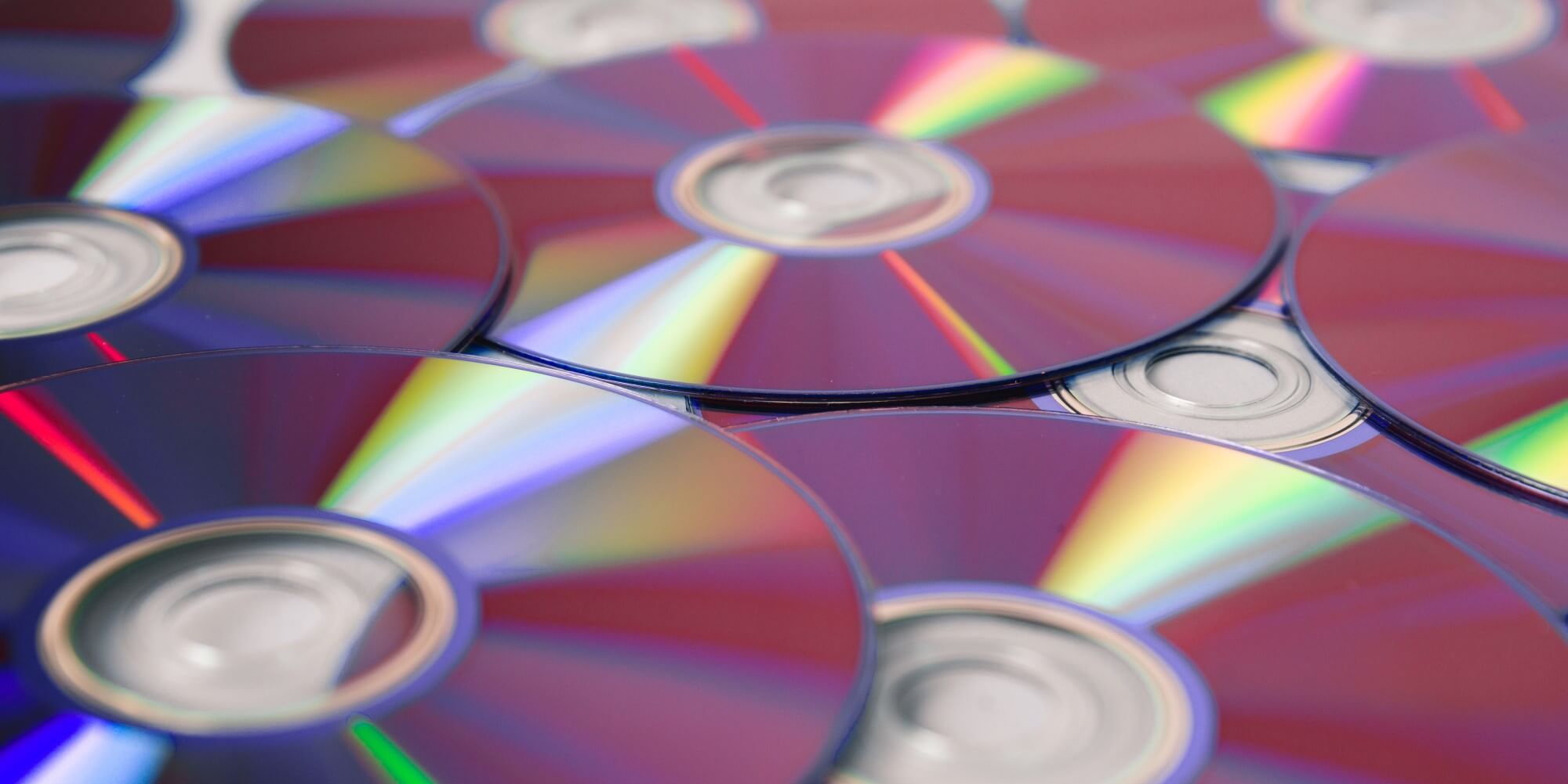 cds updside down on a table to show the colorful reflective surfaces